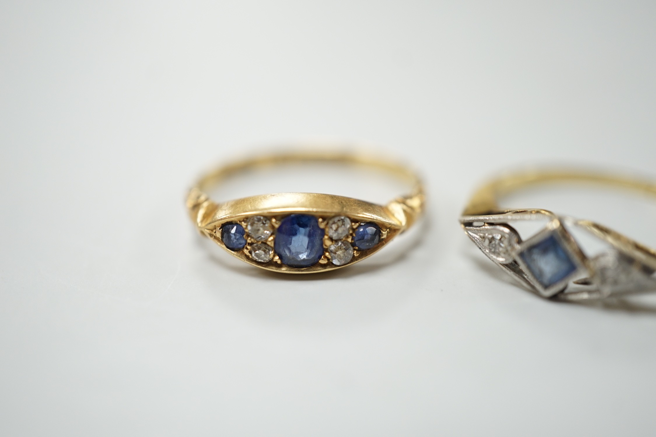 Two early 20th century 18ct, sapphire and diamond set rings, including Edwardian seven stone, size L and K/L